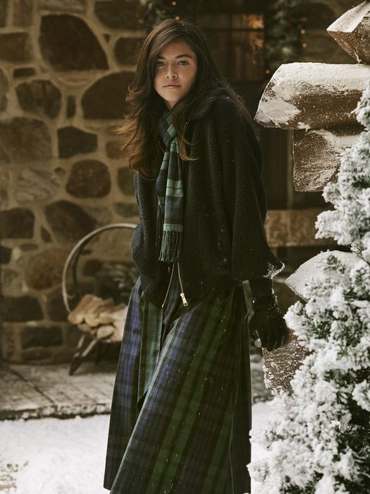 Model wearing the dress amid snowflakes