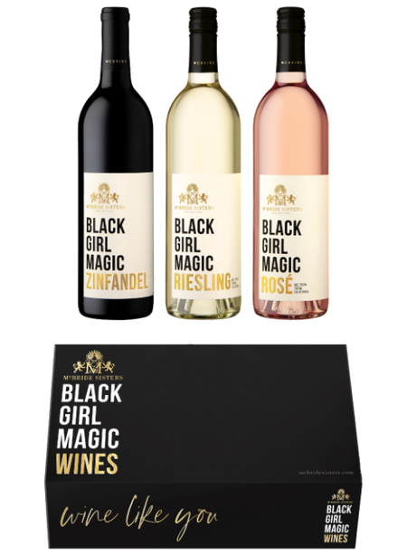 Three bottles of wine nestled in an elegant black gift box.