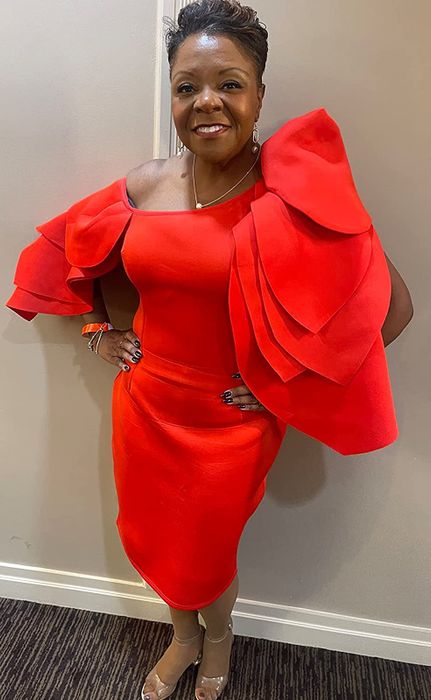 A customer modeling the dress in red