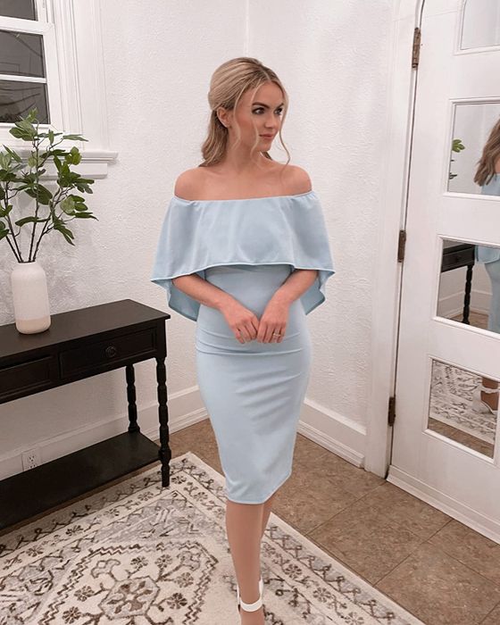 A customer models the dress in a soft blue shade, showcasing its elegant and versatile design.