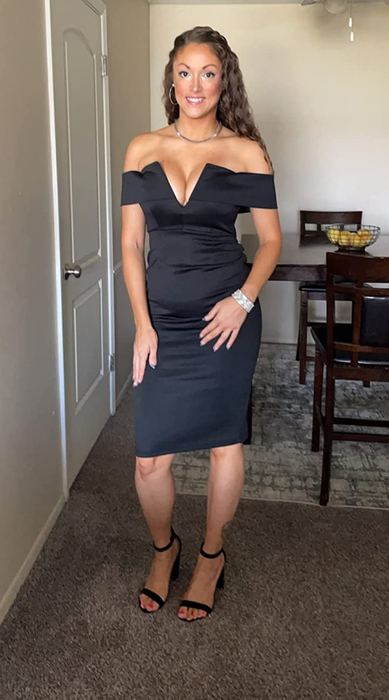 A reviewer is showcasing the dress in black.