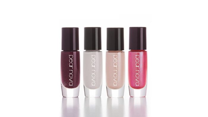Four bottles of Pear Nova nail polish in maroon, white, beige, and pink shades.