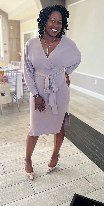 A reviewer showcasing the dress in a charming pink hue