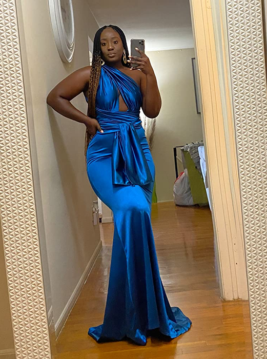 A reviewer modeling the dress in blue, with the straps tied at the front.