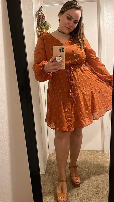 A reviewer sporting the dress in vibrant orange.