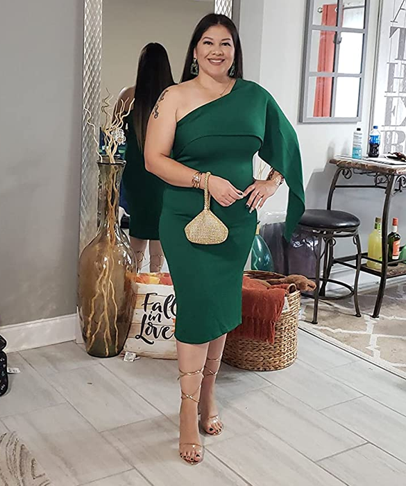 A reviewer showcasing the dress in a vibrant green color.