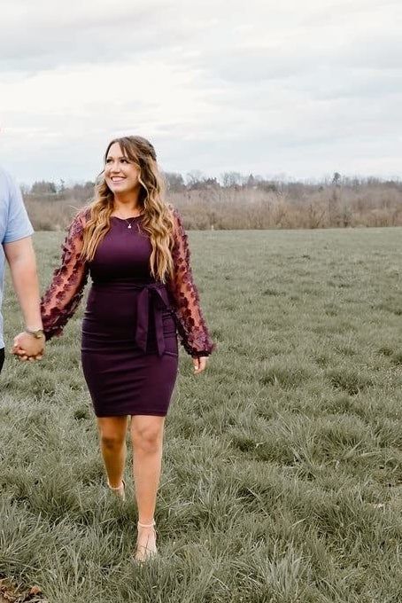 reviewer wearing the dress in red