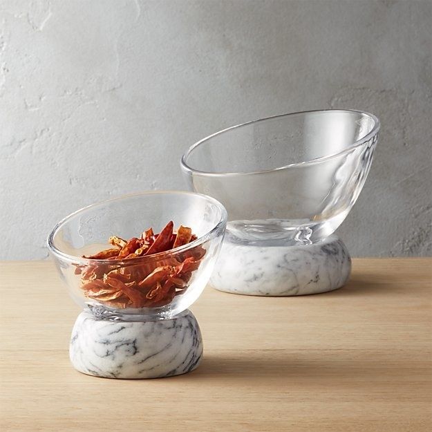 A small glass snack bowl with a marble base, placed in front of a larger version for comparison.