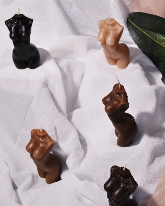 Torso-shaped candles in a variety of skin tones, each unique and beautiful in its representation.