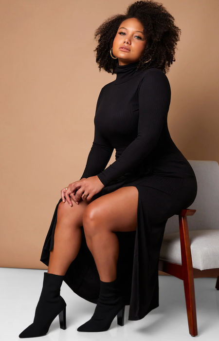 A model elegantly showcases a black midi dress, highlighting its chic slit detail.