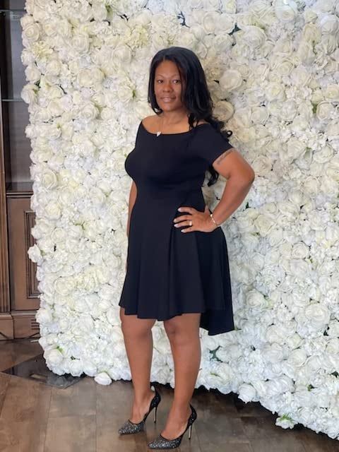 A reviewer styling the dress in classic black.