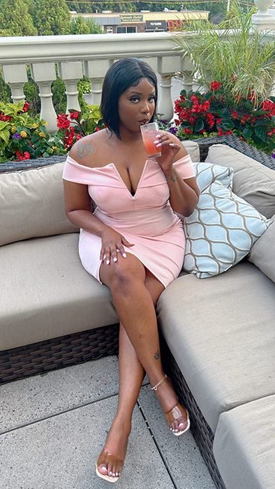 A reviewer is showing off the dress in pink.