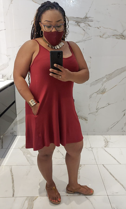 A mirror selfie from a reviewer showing someone in a red tank dress with a matching face mask