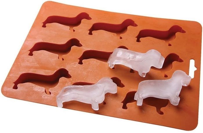 Three playful dachshund-shaped ice cubes sitting atop an ice tray, ready to chill your drink with a dash of charm.