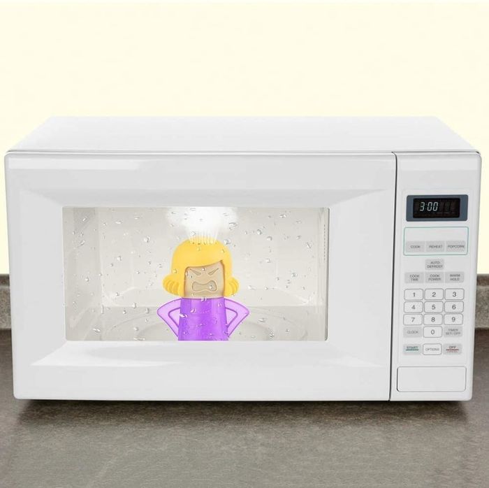 The Angry Mom Microwave Cleaner in action inside a microwave, steam billowing from the top as it works its magic.