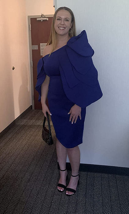 A customer showcasing the dress in blue