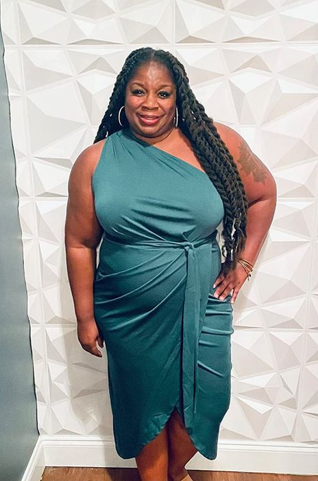 A reviewer sporting the dress in a bold green color.