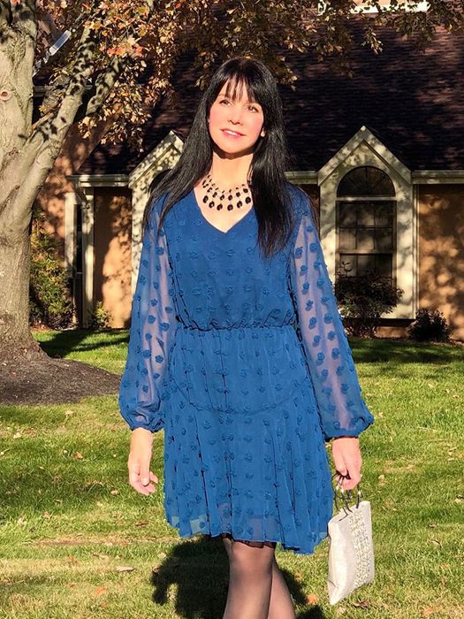 A reviewer modeling the dress in bold blue.