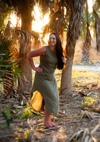 Reviewer showcasing the olive green version of the dress.