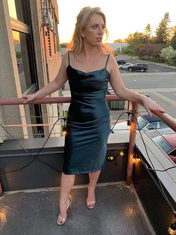 Reviewer in the black version of the dress.