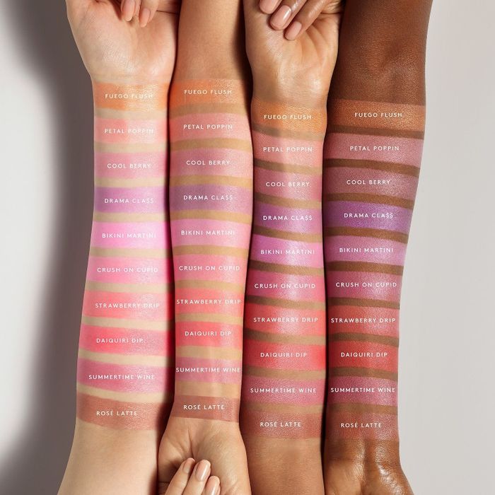 Four models with varying skin tones, from light to dark, displaying swatches of all the available blush shades