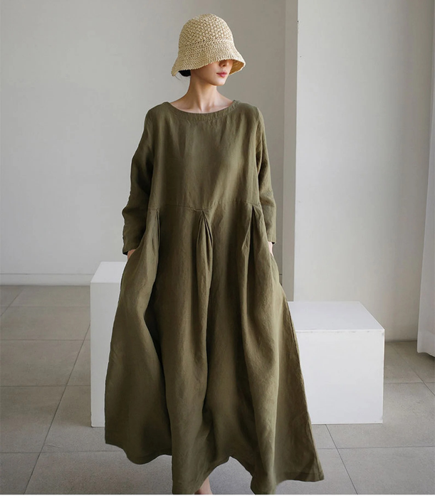 A model dressed in a vibrant green dress.