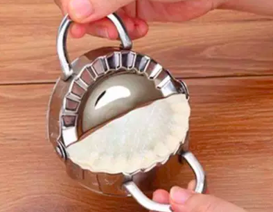 A folded pastry with perfectly crimped edges, formed within the pastry mold for a flawless finish.