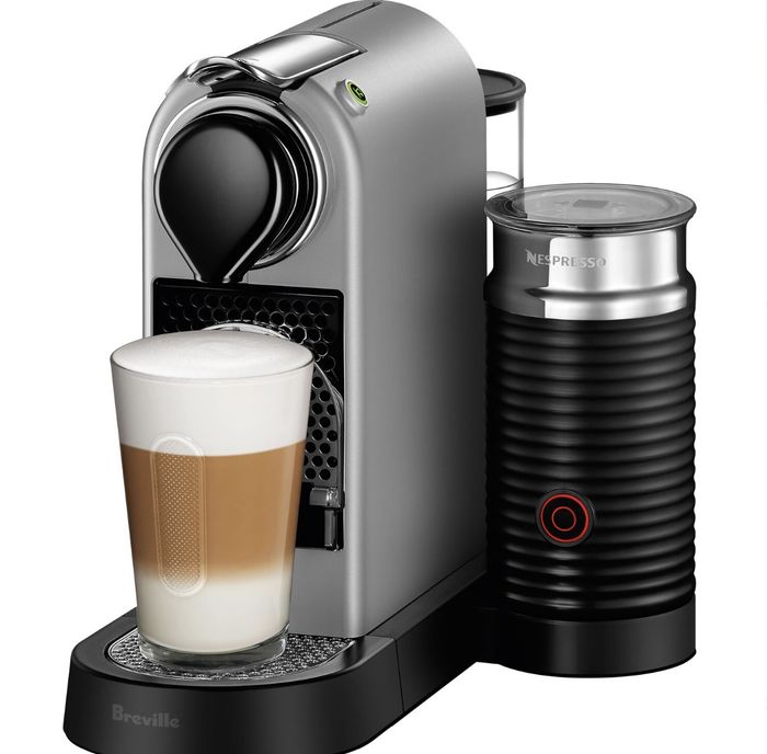 The sleek black and silver Nespresso machine, bearing the 