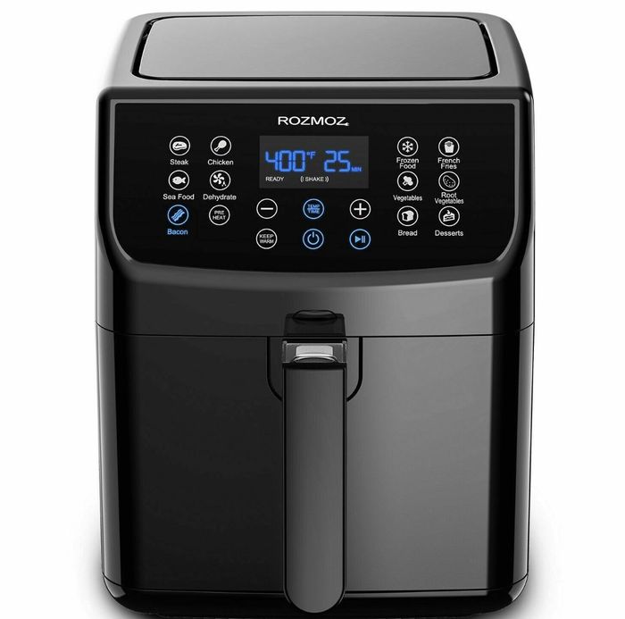 The air fryer is sleek, black with white buttons and blue digital numbers.