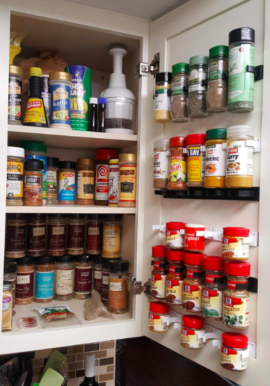 Spice-gripper clips hanging neatly on the inside of a cabinet door, saving valuable kitchen space.