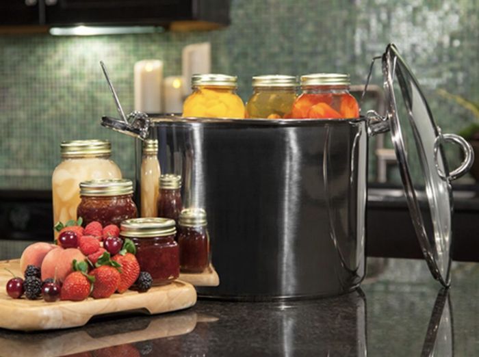 The stainless steel set features a variety of jarred items both inside and around it.