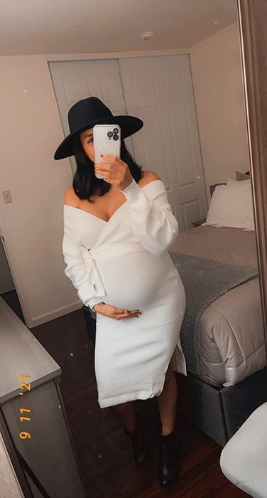 A reviewer wearing the off-shoulder dress in white