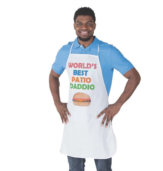 An adult wearing a white apron that says