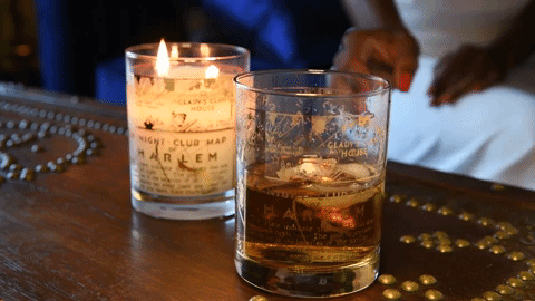 gif of a lit candle next to a glass jar now repurposed as a cocktail glass