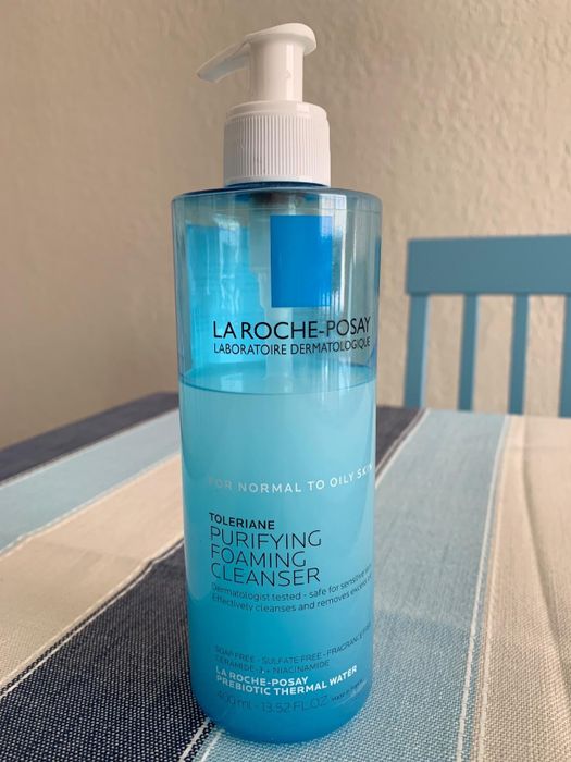 Image of a reviewer holding a bottle of La Roche-Posay purifying foaming cleanser.