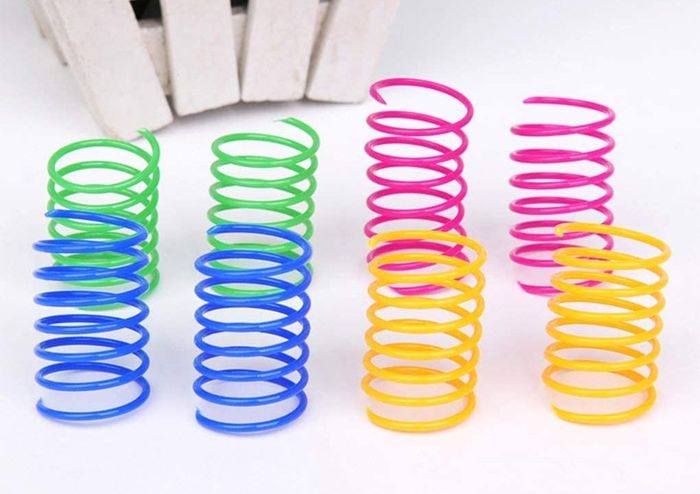 The set of springs comes in vibrant colors including green, blue, pink, and yellow.
