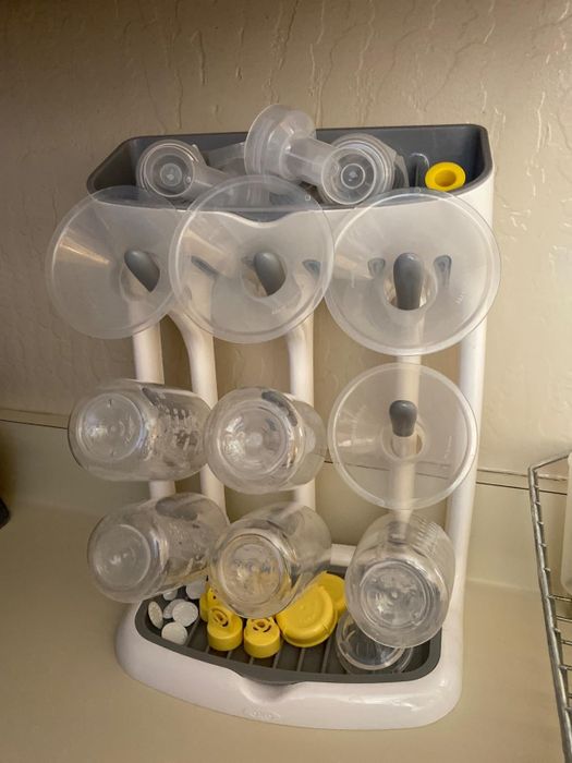 photo of the vertical drying rack filled with baby bottles and various baby products