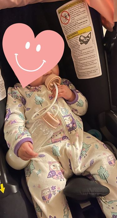 A reviewer photo of a baby using the bottle hands-free.