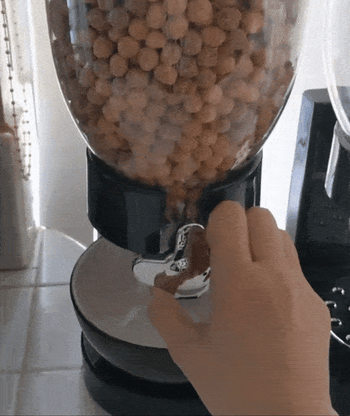 A reviewer GIF showing someone dispensing cereal into a bowl.