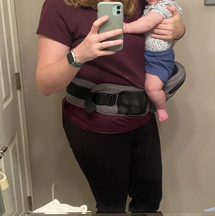 A reviewer provides a close-up view of the carrier, highlighting its convenient front pocket.
