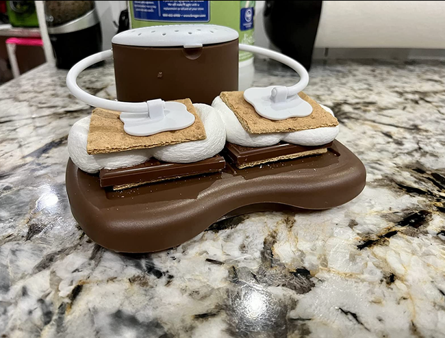 A reviewer image of the s'mores maker holding two freshly made s'mores.