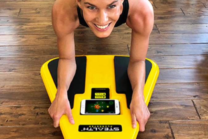 An overhead shot of someone using the board, with a video game streaming from their phone, blending fitness and gaming seamlessly.