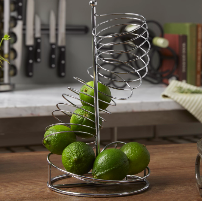 A sleek, stainless steel upright spiral fruit basket