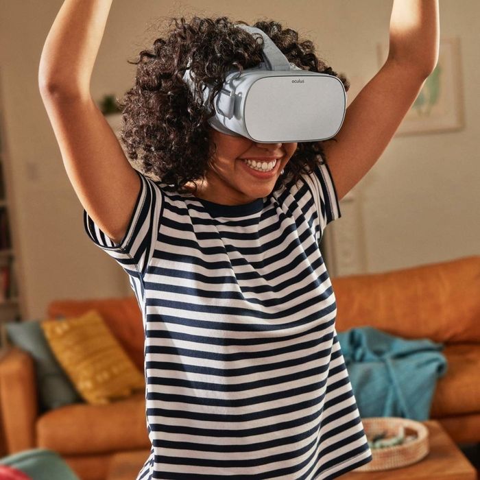A person wearing the Oculus Go VR headset, which covers their eyes for full immersion.