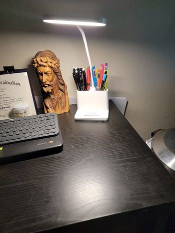 A review image showing the LED desk lamp neatly placed on a desk.