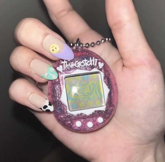 A reviewer holding the compact, palm-sized toy in their hand, showcasing its nostalgic charm.