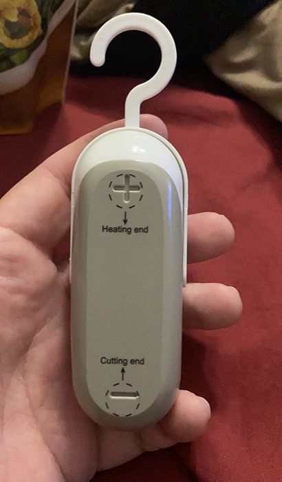 A reviewer demonstrates how easy it is to seal bags with the handy little bag sealer in hand.