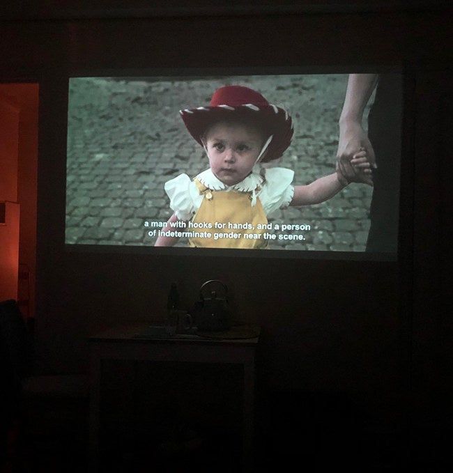 The image from the pocket projector displayed clearly on a wall in a dark room, providing a sizable and sharp projection.