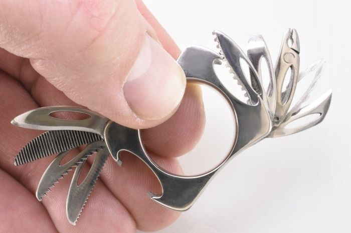 A detailed view of the ring, showcasing nine different miniature tools extending from both sides.