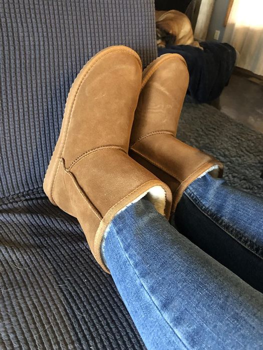 A reviewer showcasing the tan-colored boots.